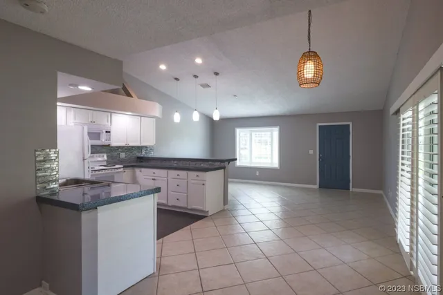a kitchen with stainless steel appliances a sink stove and cabinets