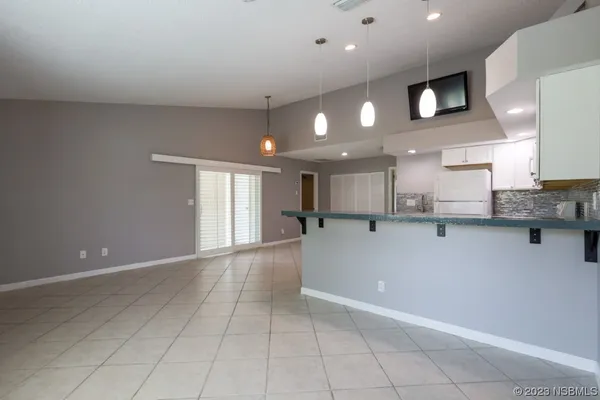 a kitchen with stainless steel appliances kitchen island granite countertop a stove a sink a refrigerator and a microwave