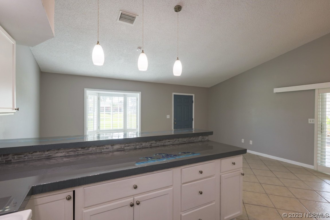 14 Chip Lane New Smyrna Beach, FL 32168 - Photo 39 of 54 a kitchen with granite countertop cabinets and window