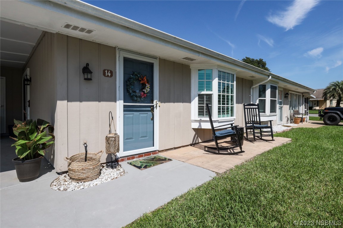 14 Chip Lane New Smyrna Beach, FL 32168 - Photo 4 of 54 a view of a house with backyard sitting area and porch