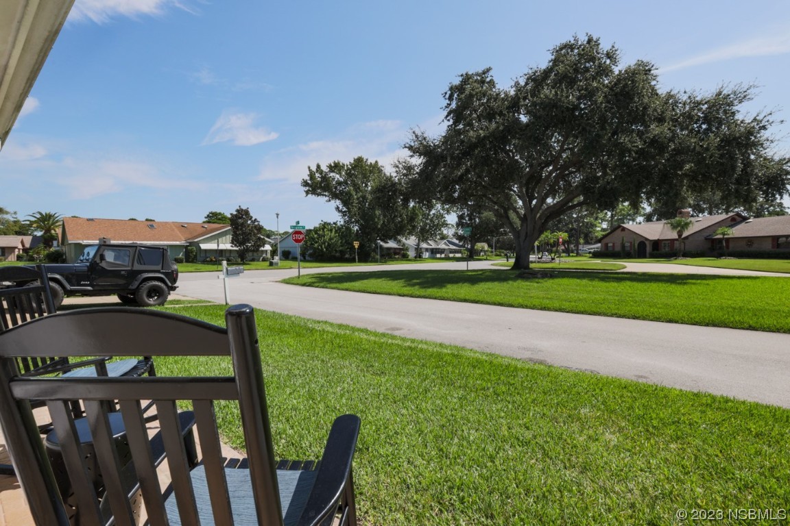 14 Chip Lane New Smyrna Beach, FL 32168 - Photo 50 of 54 a view of yard with seating area and trees in the background