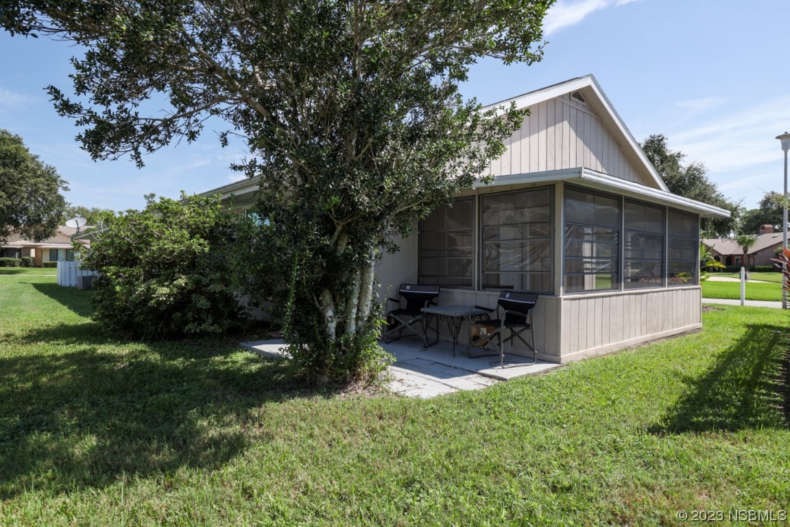 14 Chip Lane New Smyrna Beach, FL 32168 - Photo 51 of 54 a view of house with a yard and sitting area