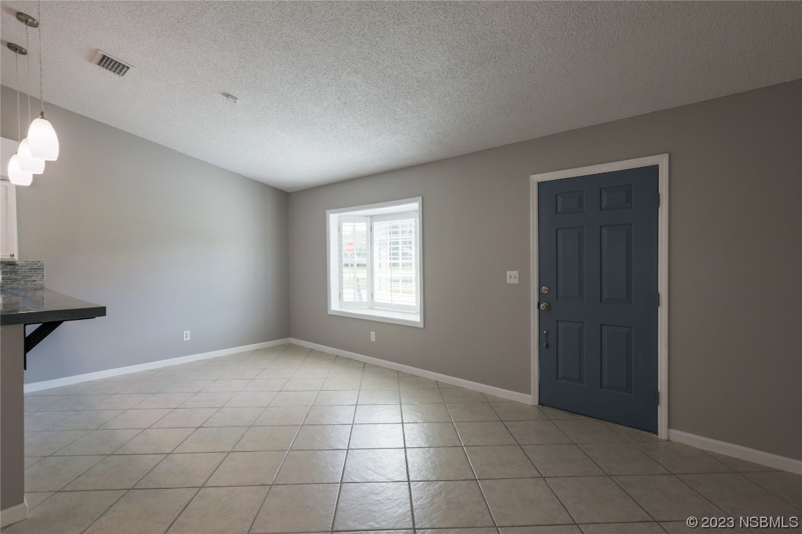 14 Chip Lane New Smyrna Beach, FL 32168 - Photo 6 of 54 a view of an empty room with a window
