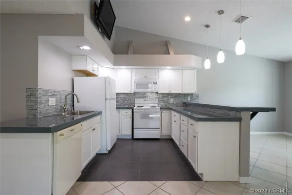 a kitchen with stainless steel appliances a sink stove and cabinets