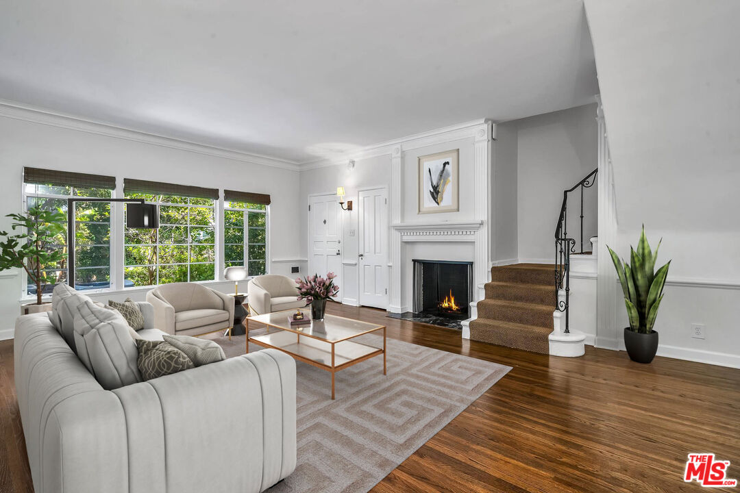 360 South Roxbury Drive Beverly Hills, CA 90212 - Photo 1 of 30 a living room with furniture and a fireplace