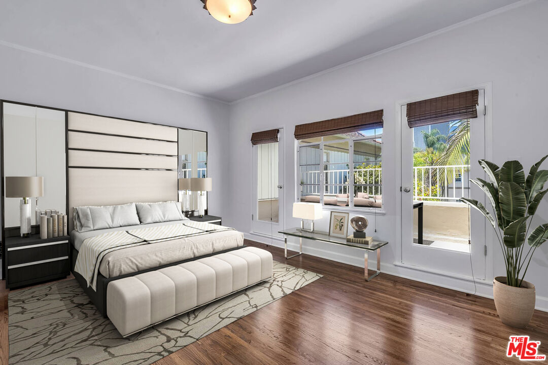 360 South Roxbury Drive Beverly Hills, CA 90212 - Photo 13 of 30 a bedroom with a large bed and a potted plant