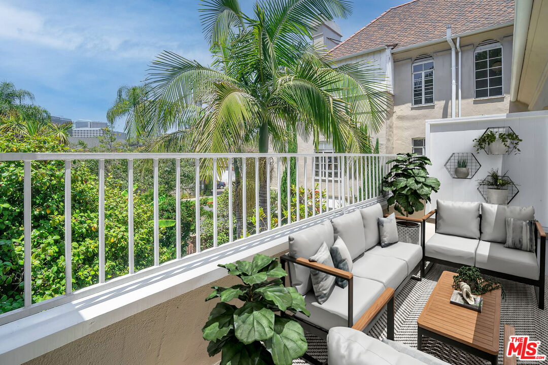 360 South Roxbury Drive Beverly Hills, CA 90212 - Photo 14 of 30 a view of a patio with couches table and chairs with potted plants