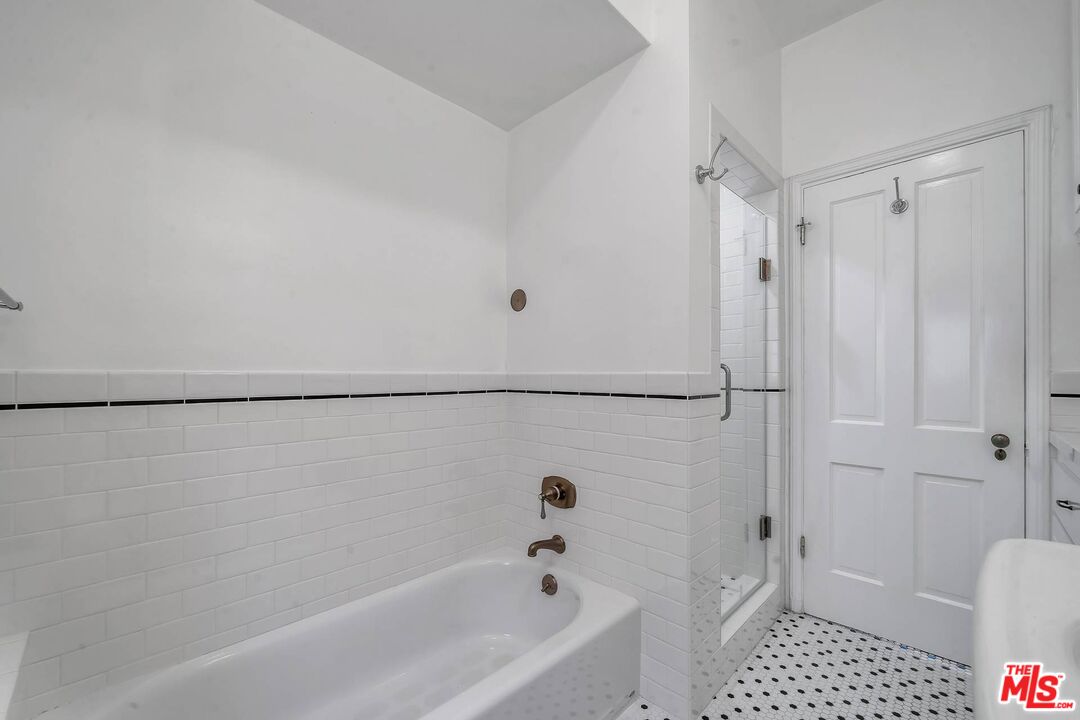 360 South Roxbury Drive Beverly Hills, CA 90212 - Photo 20 of 30 a bathroom with a bathtub and a shower