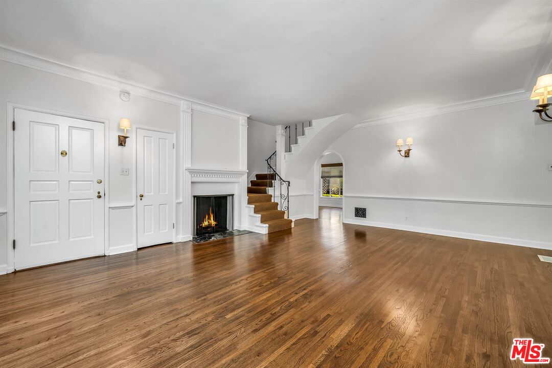 360 South Roxbury Drive Beverly Hills, CA 90212 - Photo 7 of 30 a view of a livingroom with wooden floor and a fireplace