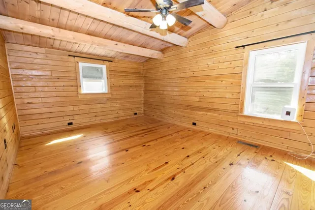 a backyard of a house with barbeque oven fire pit table and chairs