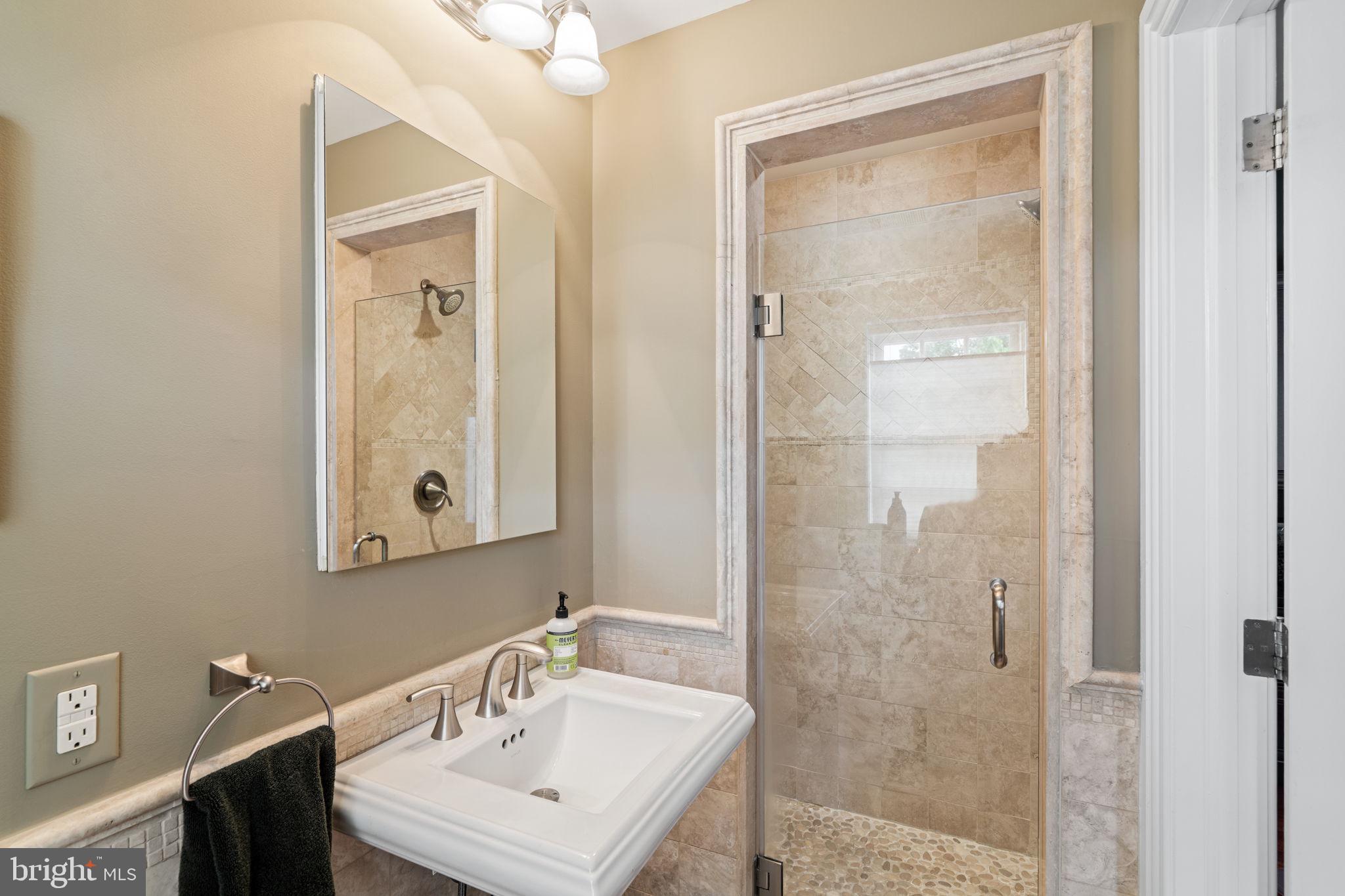 501 Pine Street Philadelphia, PA 19106 - Photo 39 of 52 a bathroom with a sink a mirror a vanity and a shower