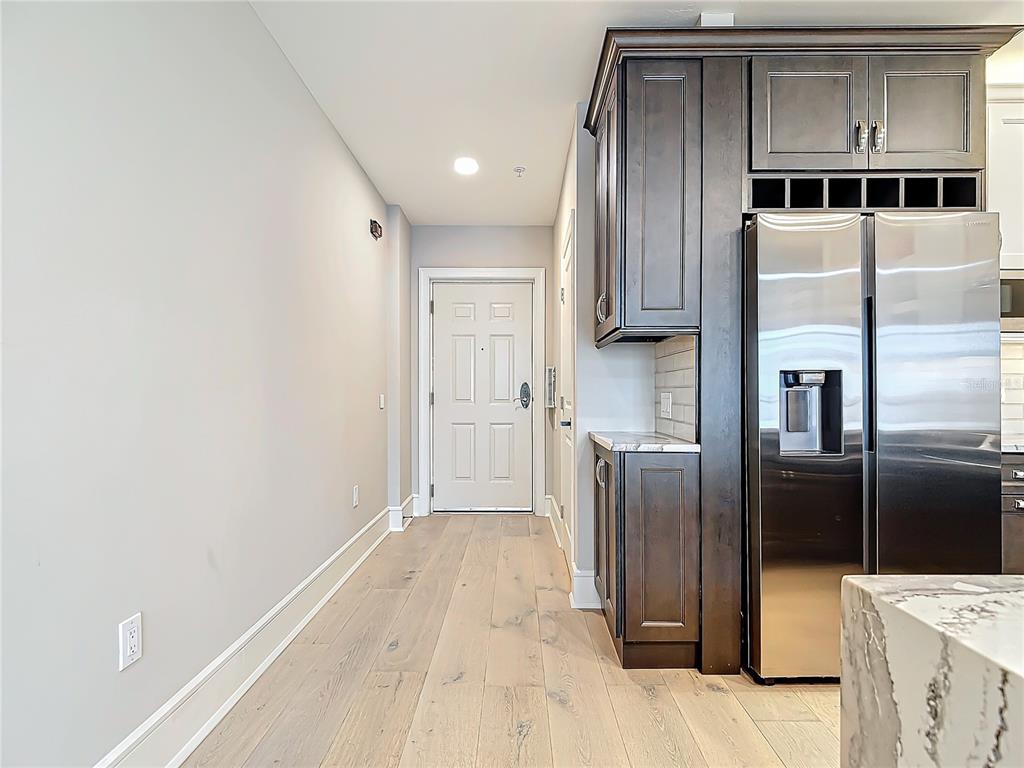 2745 First Street, Unit 111 Fort Myers, FL 33916 - Photo 11 of 79 a kitchen with stainless steel appliances a refrigerator and a counter top