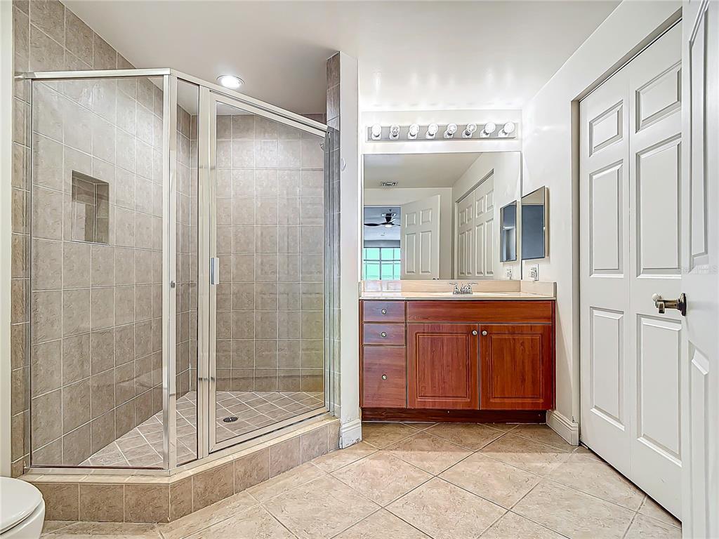 2745 First Street, Unit 111 Fort Myers, FL 33916 - Photo 29 of 79 a bathroom with a shower sink and mirror