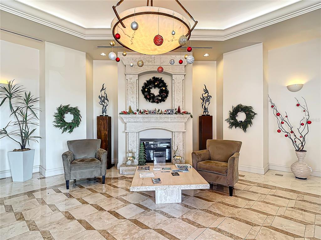 2745 First Street, Unit 111 Fort Myers, FL 33916 - Photo 37 of 79 a living room with furniture and a fireplace