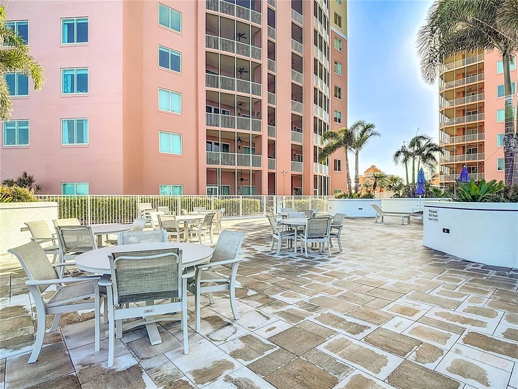 2745 First Street, Unit 111 Fort Myers, FL 33916 - Photo 52 of 79 a view of a patio with a dining table and chairs