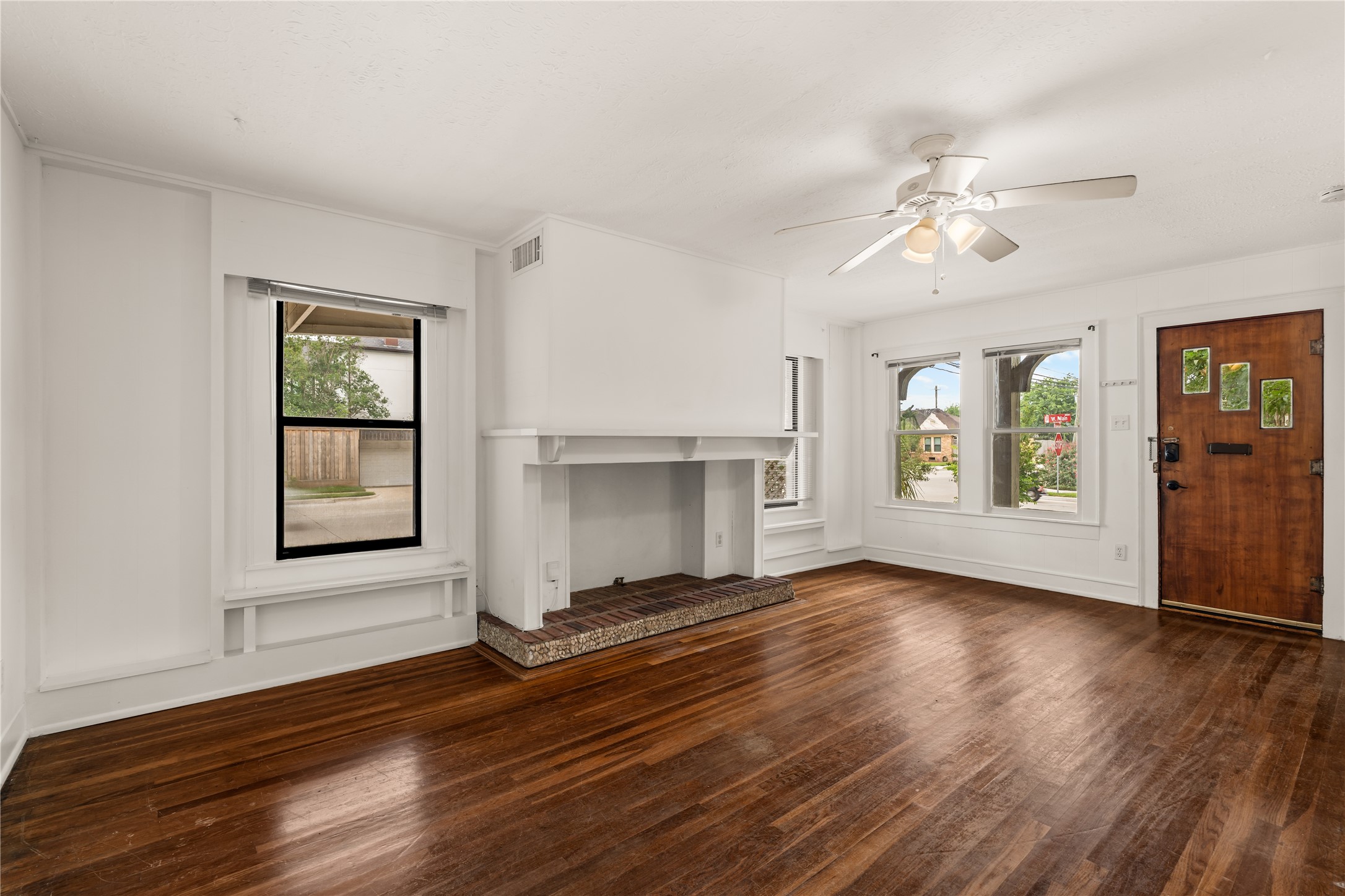 2202 West Main Street Houston, TX 77098 - Photo 6 of 32 a view of an empty room with wooden floor and a window