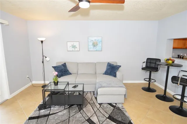 a living room with lots of furniture and wooden floor