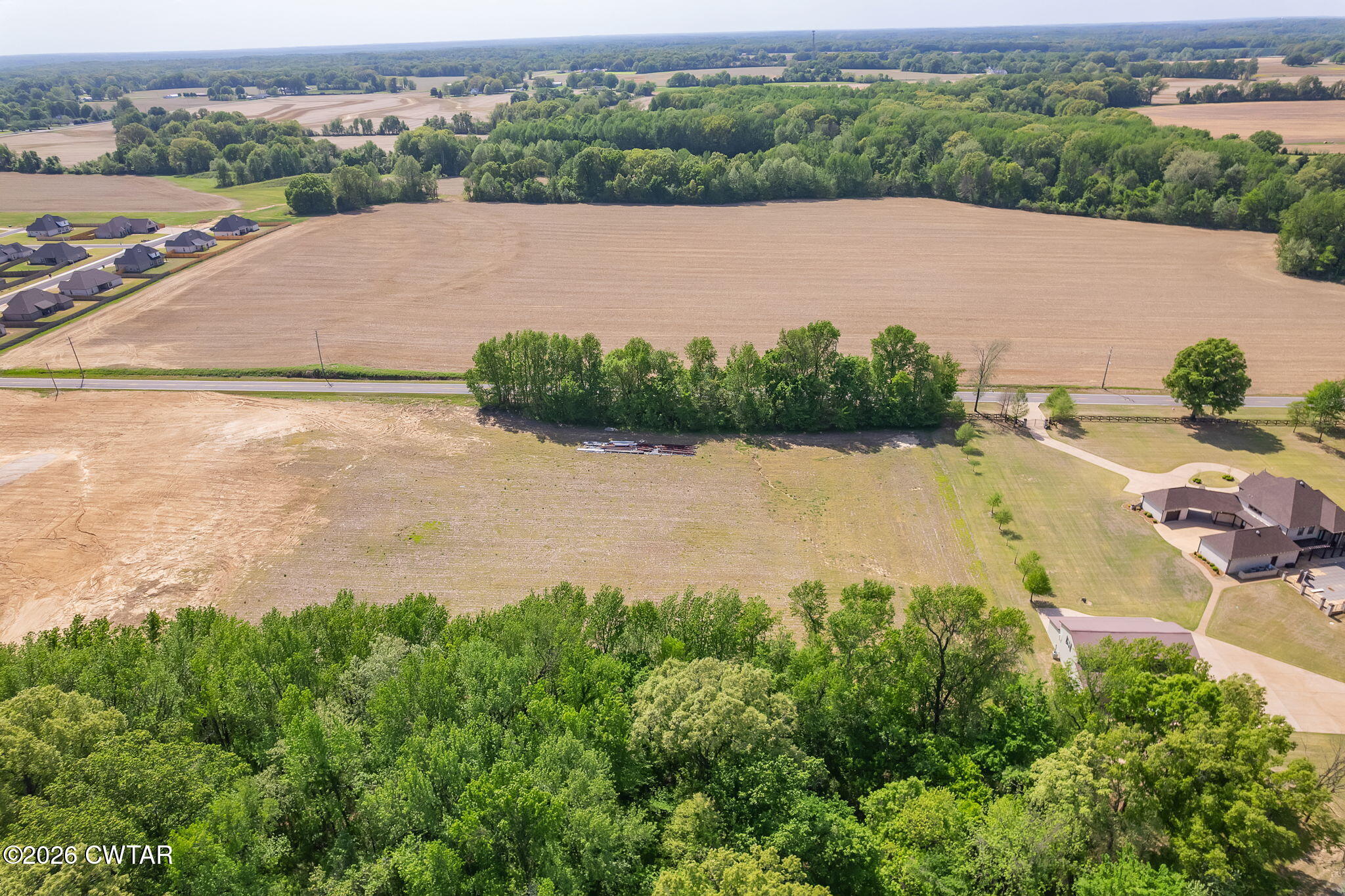 0 Windy City Road Jackson, TN 38305 - Photo 6 of 24 an aerial view of green landscape with trees houses and lake view