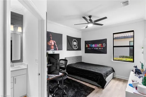 a bedroom with a bed and a chandelier
