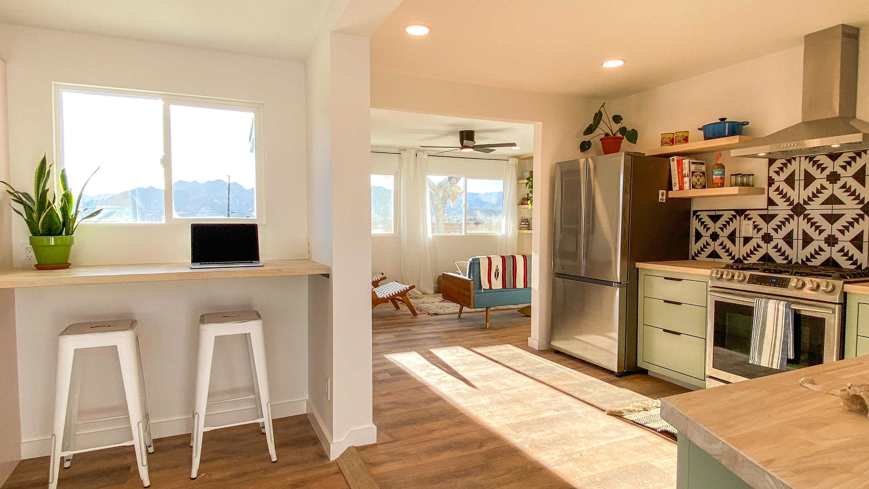 6126 Panorama Road Joshua Tree, CA 92252 - Photo 15 of 31 a kitchen with stainless steel appliances kitchen island granite countertop a refrigerator and a sink