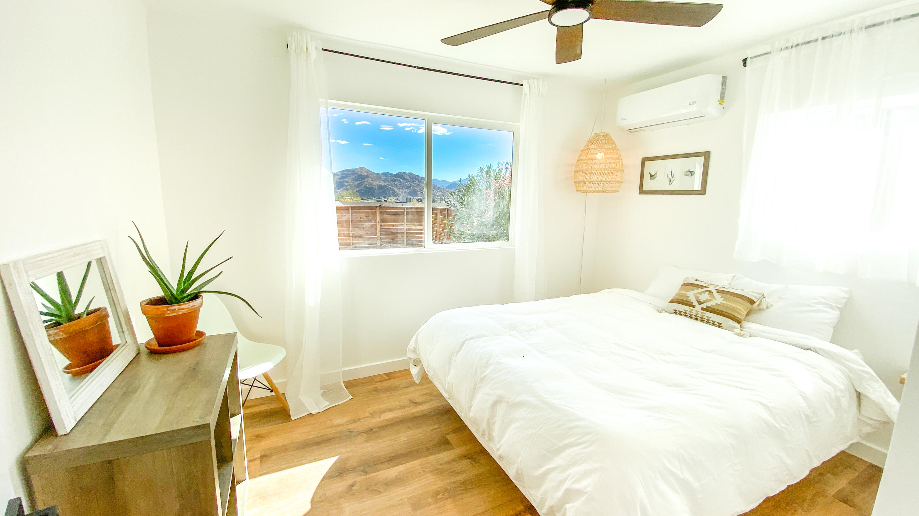 6126 Panorama Road Joshua Tree, CA 92252 - Photo 19 of 31 a bedroom with a bed and chandelier