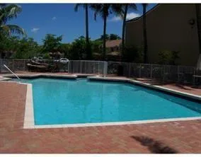 swimming pool view with a seating space