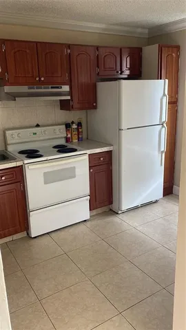 a kitchen with a cabinets and a refrigerator