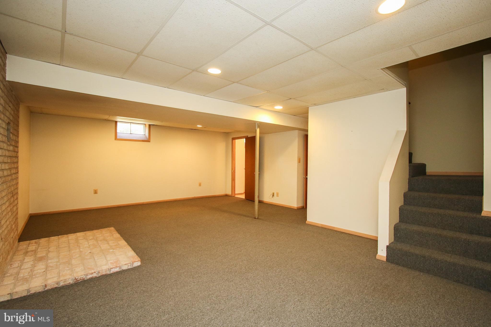 300 Warfieldsburg Road Westminster, MD 21157 - Photo 22 of 30 a view of an empty room with stairs and a window