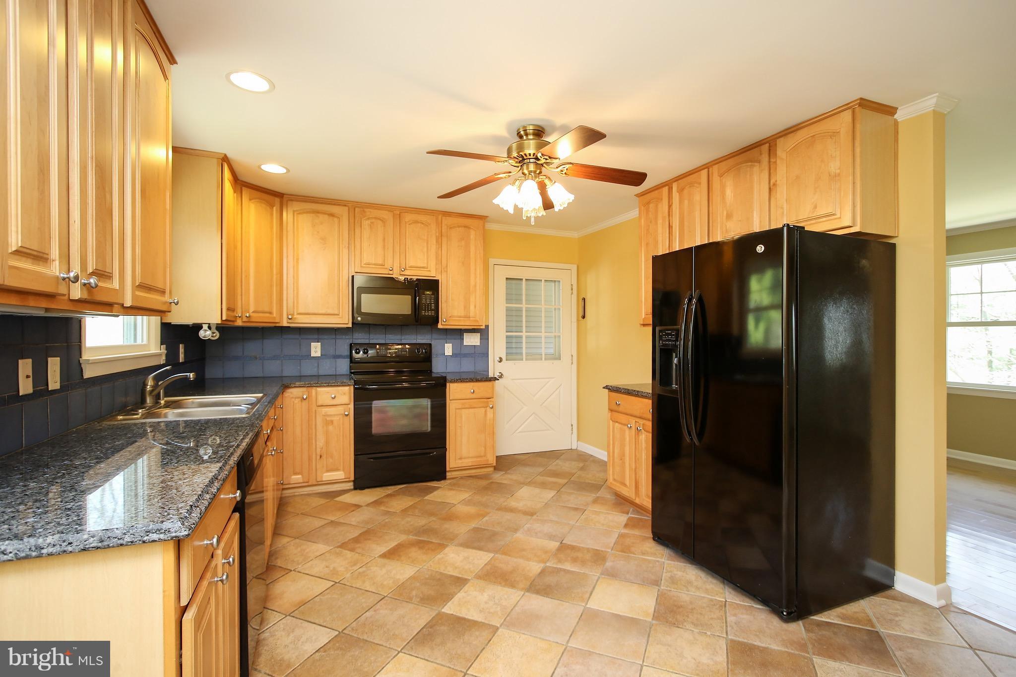 300 Warfieldsburg Road Westminster, MD 21157 - Photo 8 of 30 a kitchen with granite countertop a refrigerator and a sink