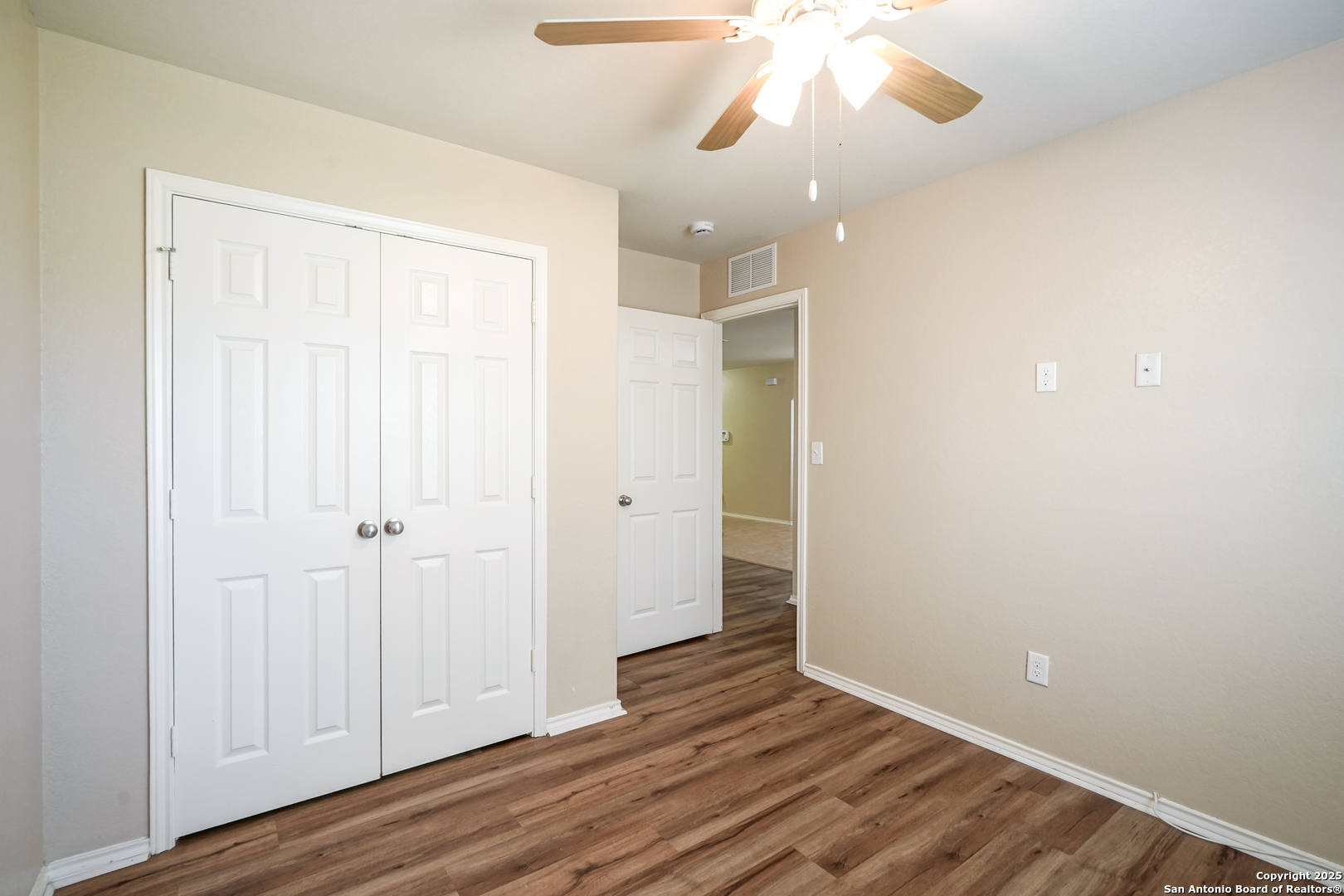 438 Walnut Crest Selma, TX 78154 - Photo 18 of 33 an empty room with wooden floor and windows
