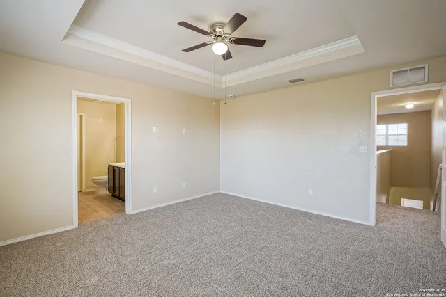 a view of a livingroom with a ceiling fan and window