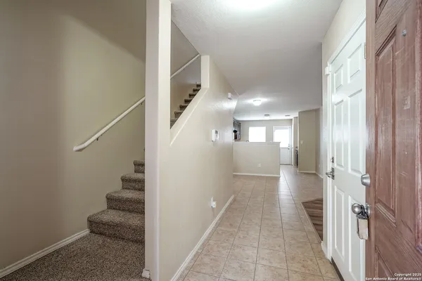 a view of a hallway with wooden floor and entryway