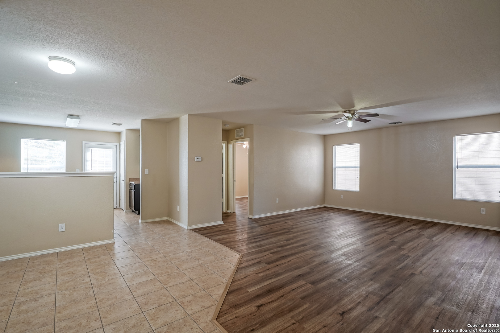 438 Walnut Crest Selma, TX 78154 - Photo 7 of 33 a view of an empty room with window and wooden floor