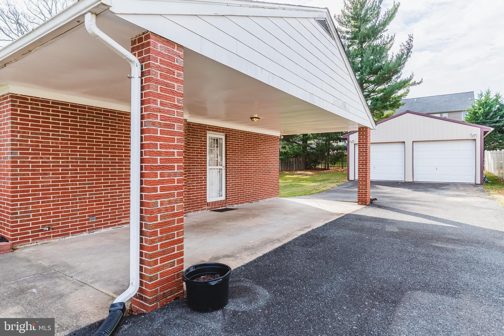 Carport and driveway that leads to back of house.