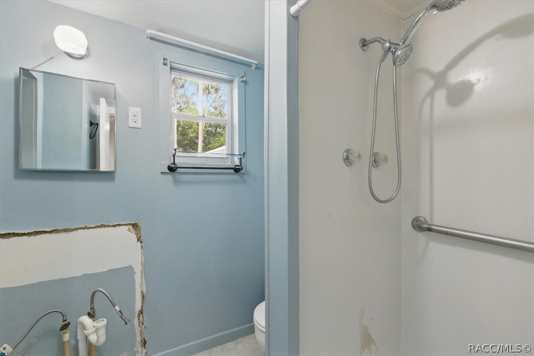 6 62nd Street Yankeetown, FL 34498 - Photo 49 of 55 a bathroom with a window and a shower