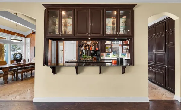 a kitchen with stainless steel appliances granite countertop a stove refrigerator and cabinets