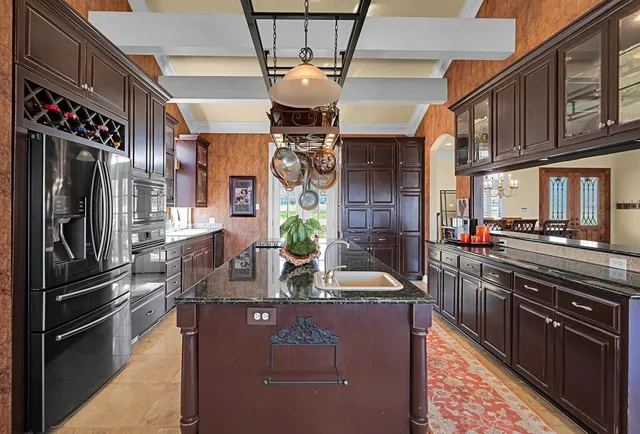 a kitchen with stainless steel appliances granite countertop a sink stove and cabinets