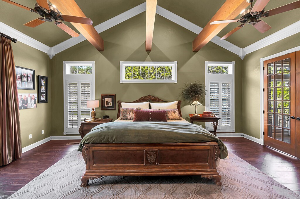 675 Cedar Canyon Road Crawford, TX 76638 - Photo 24 of 95 a spacious bedroom with a bed and wooden floor