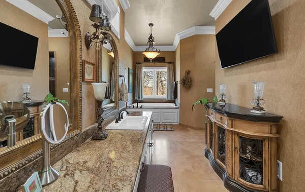 a bedroom with a bed and a chandelier