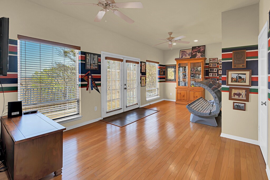 675 Cedar Canyon Road Crawford, TX 76638 - Photo 36 of 95 a living room with furniture and a book shelf