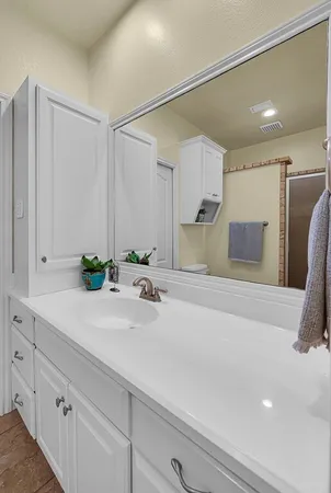 a view of a house with a yard deck and a forest