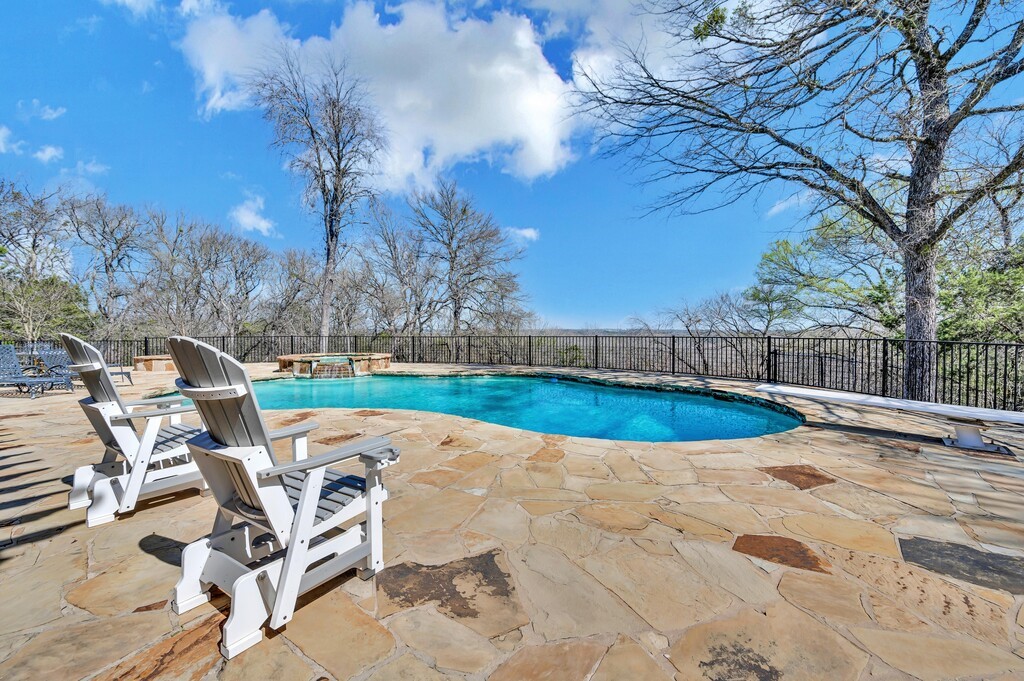 675 Cedar Canyon Road Crawford, TX 76638 - Photo 56 of 95 a view of a swimming pool with lounge chair