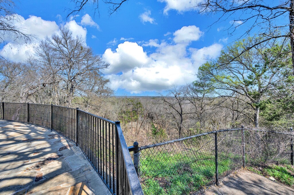 675 Cedar Canyon Road Crawford, TX 76638 - Photo 57 of 95 a view of a backyard with wooden fence