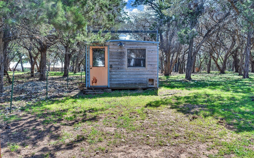 675 Cedar Canyon Road Crawford, TX 76638 - Photo 62 of 95 a front view of a house with a garden