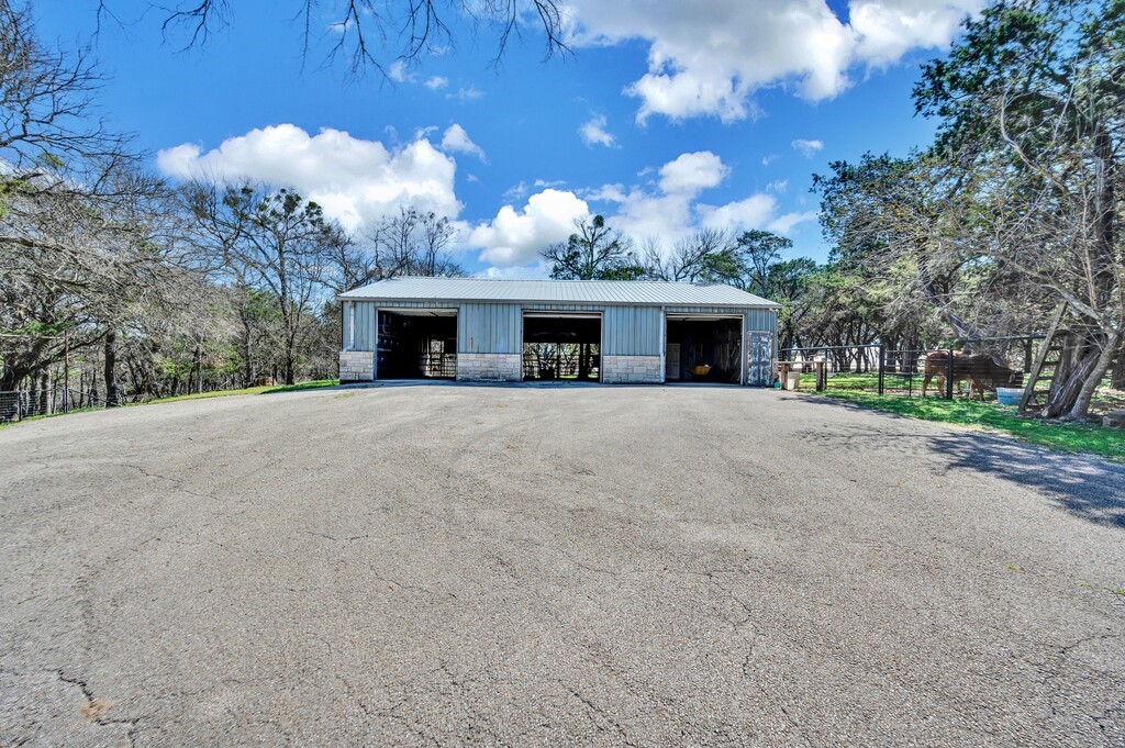 675 Cedar Canyon Road Crawford, TX 76638 - Photo 63 of 95 a view of a house with a yard and garage