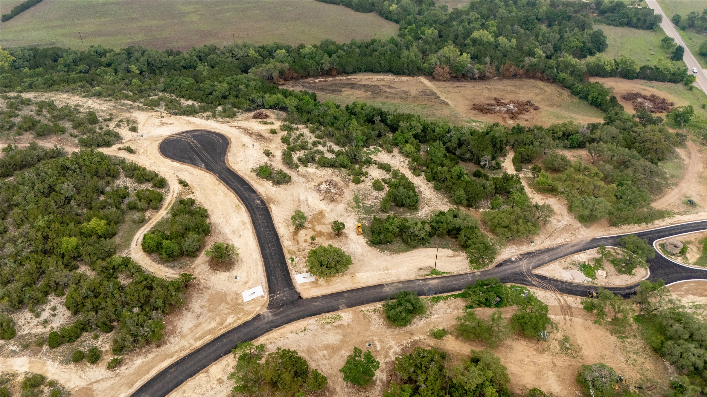 Lot 26 Ranch Road 165 Dripping Springs, TX 78620 - Photo 4 of 13 Newly paved roads winding through a natural landscape
