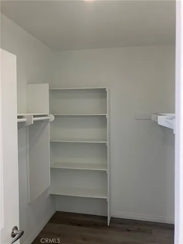 a view of walk in closet with empty racks