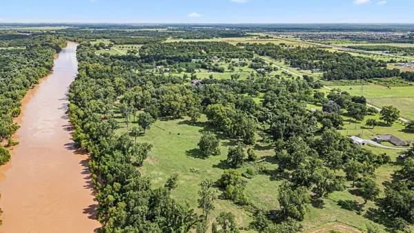a view of a green field with an ocean view
