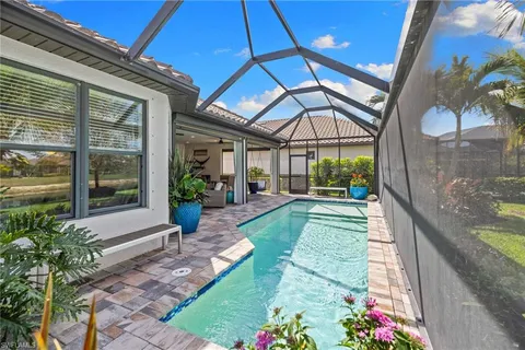 a view of a patio with a table and chairs under an umbrella