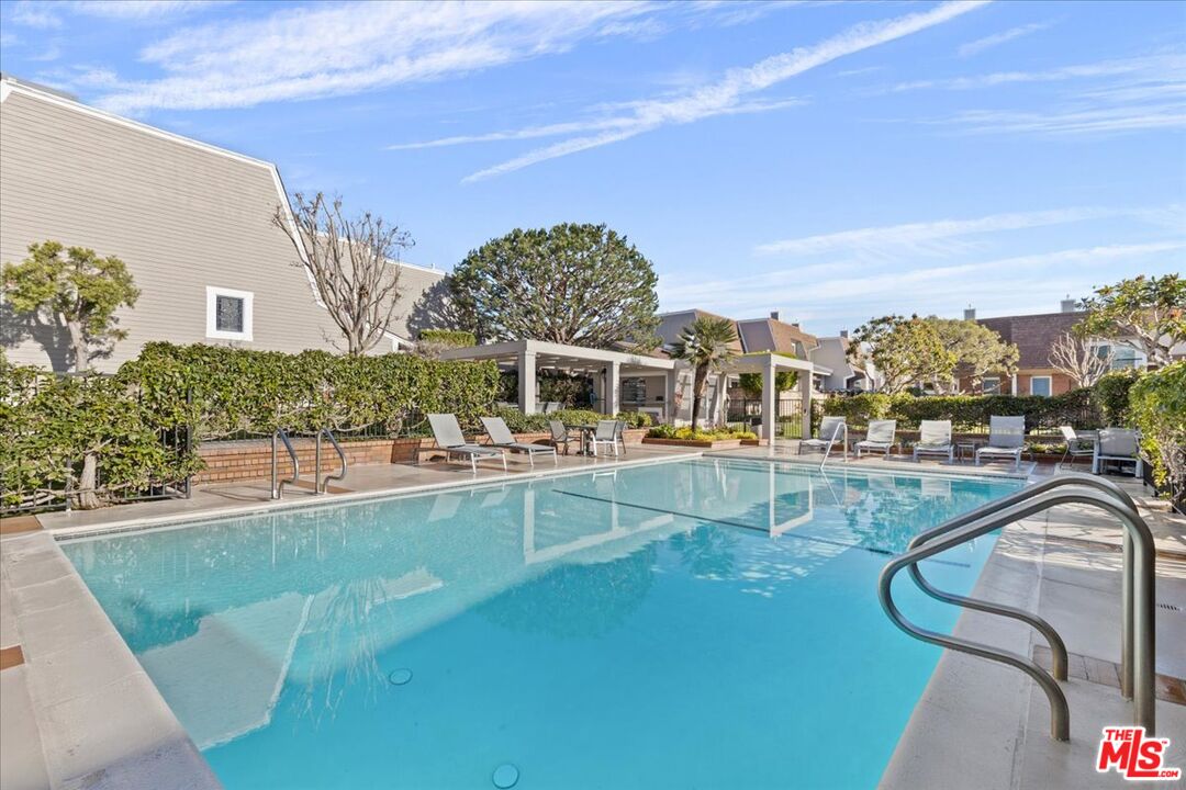 4351 Alla Road, Unit 8 Marina del Rey, CA 90292 - Photo 15 of 31 a view of a swimming pool with a lawn chairs and potted plants
